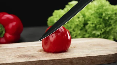 Sliced red tomato spread on a chopping board Stock Footage 208819871