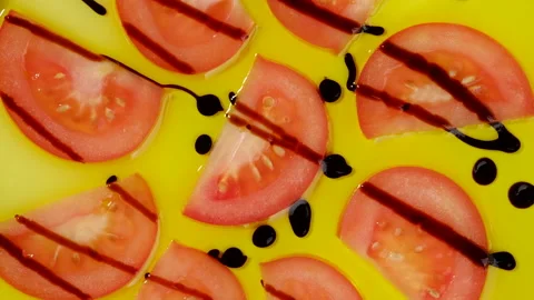 Sliced red tomatoes with balsamic Modena in olive oil rotating Stock-Footage 130254152