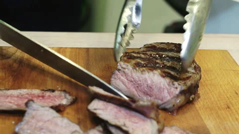 Sliced ribeye steak on a wooden board. Close-up. Stock Footage 171624853