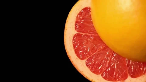 Sliced ripe grapefruit halves on black background Vídeos de archivo 150061659
