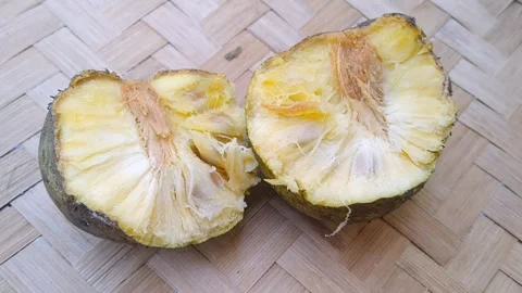 Sliced Ripe Mountain Soursop Fruit Exposing Fresh Yellow Pulp Halves Stock Footage 340125545