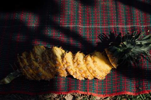 Sliced ripe pineapple on the beach Stock Photos