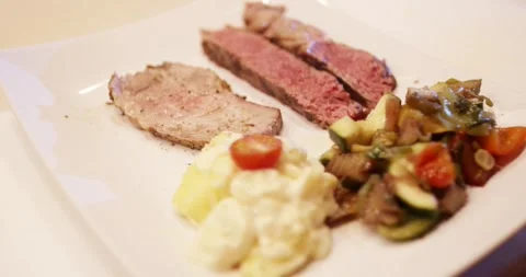 Sliced Roast Beef with Potato Salad and Vegetables, Plated Dish, Close Up Shot Stock Footage 340322989