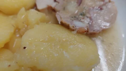 Sliced roasted chicken roll with stuffing and boiled potatoes close up Stock Footage 333641734