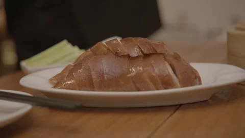 Sliced Roasted Meat Plated in Beijing Restaurant with Side Vegetables on Table Stock Footage 345769460