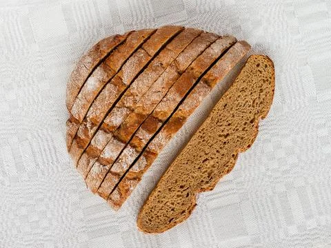 Sliced round loaf of rye bread with an appetizing crispy brown crust. Stock Photos