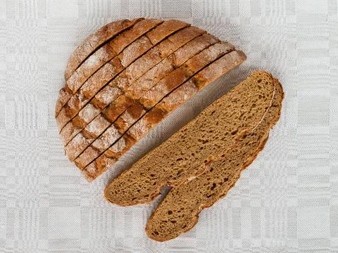 Sliced round loaf of rye bread with an appetizing crispy brown crust. Stock Photos