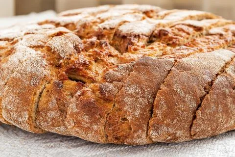 Sliced round loaf of rye bread with an appetizing crispy brown crust. Stock Photos