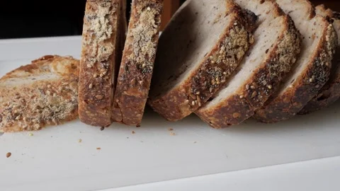 Sliced Rustic Bread with Seeds on Wooden Board for Natural Dining Stock Footage 334580423