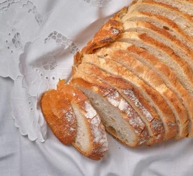 A sliced rustic bread on white napkin background Stock Photos