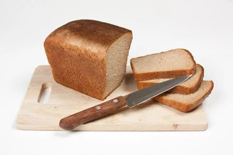 Sliced rye bread and knife Stock Photos