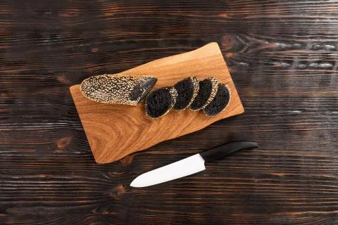 Sliced rye bread and knife on a cutting board Stock Photos