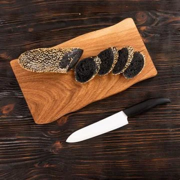 Sliced rye bread and knife on a cutting board Stock Photos