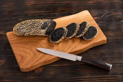 Sliced rye bread and knife on a cutting board Stock Photos