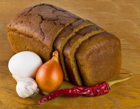 Sliced rye bread on a board Stock Photos