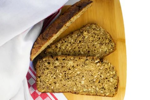 Sliced rye bread on cutting board. Whole grain rye bread with seeds. Deliciou Stock Photos