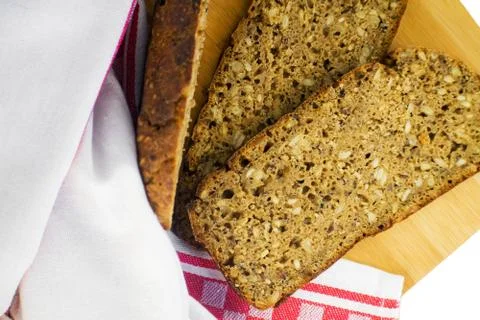 Sliced rye bread on cutting board. Whole grain rye bread with seeds. Deliciou Stock Photos