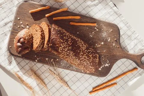 Sliced rye bread on cutting board. Whole grain rye bread with seeds Stock Photos