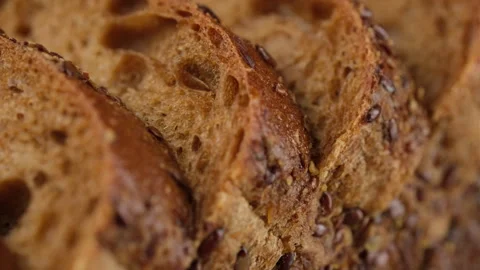 Sliced rye bread with flax seeds, slider shot Video stock 241212278