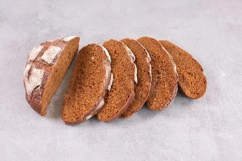 Sliced rye bread on a grey table. Stock Photos