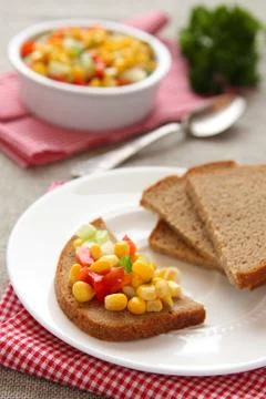 Sliced rye bread with homemade corn salsa 스톡 사진