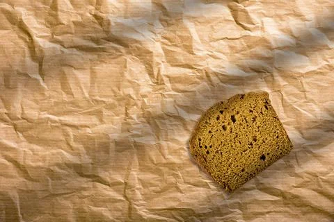 Sliced rye bread on an isolated brown background. Slices of brown bread wra.. Stock Photos