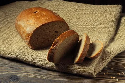 Sliced Rye Bread Loaf On Burlap On Wooden Table Fotos Stock