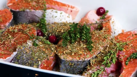 Sliced salmon decorated with thyme, cranberries, spices Stock Footage 149686179