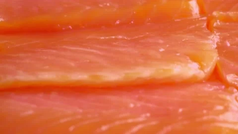 Sliced salmon fish, close up slow motion video, lots of salmon fillet, raw red Stock Footage 228219605