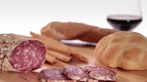 Sliced saucisson with wine and bread 库存影片 31308373