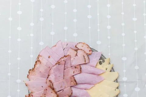 Sliced sausage, ham and cheese on a plate. Stock Photos
