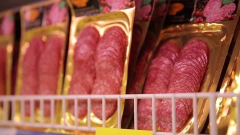 Sliced sausage in a vacuum package in a storefront at the grocery store Stock Footage 75488957