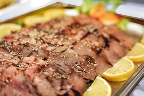 Sliced seasoned roast beef on a buffet table Stock Photos