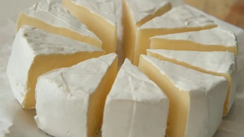 Sliced sectors of soft cheese brie or camambert rotating, close up Stock Footage 125179596