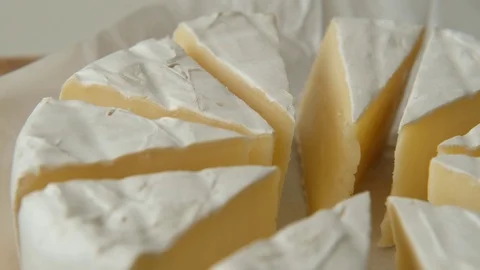 Sliced sectors of soft cheese brie or camambert rotating, close up Video stock 125240750
