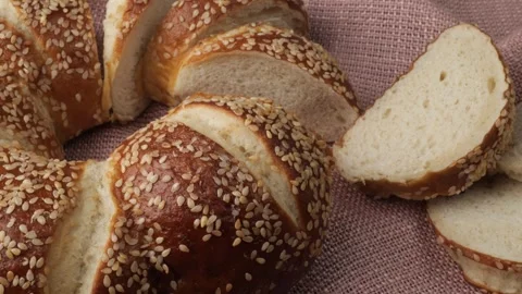Sliced sesame seed bread loaf in a studio shot Stock Footage 344603954