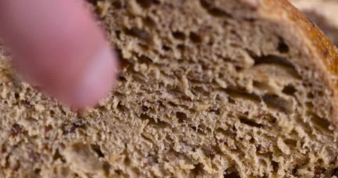 A sliced soft loaf of rye bread on the table on a cutting board, a small Stock Footage 319455377