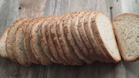 Sliced sourdough bread falling on a table. Slow Motion. 動画素材 84935176