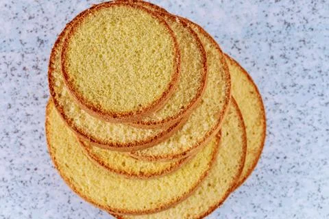 Sliced sponge cake on table for making wedding cake. Stock Photos