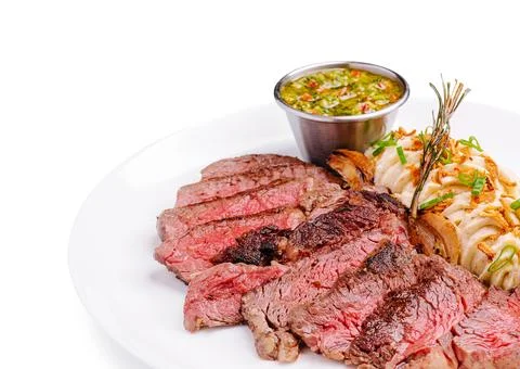 Sliced steak with mashed potatoes and chimichurri sauce Stock Photos