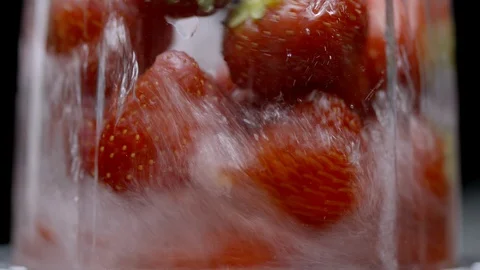 Sliced strawberries getting blended Stock Footage 128720222