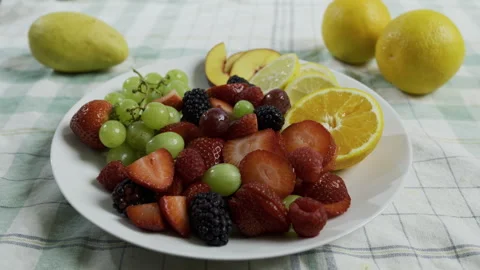 Sliced strawberries, oranges, lemons, grapes, blackberries, raspberries and Stock Footage 341189401