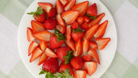 Sliced strawberries on a plate. Video stock 244364848