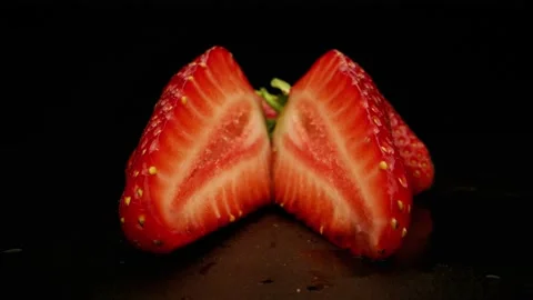 Sliced Strawberry On Black Background Camera rolling in Stock Footage 131800422