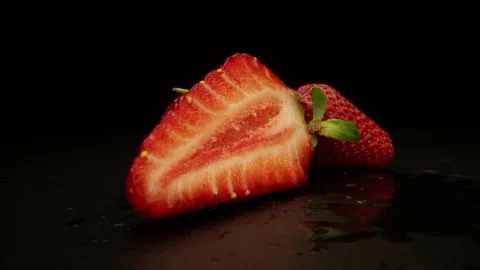 Sliced Strawberry On Black Background Stock Footage 131800437