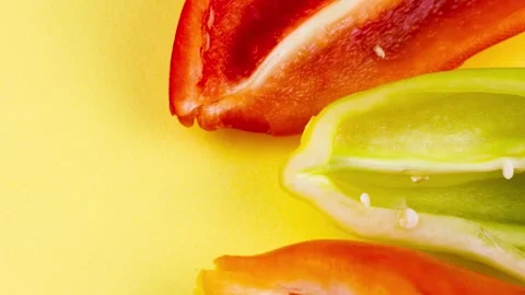 Sliced sweet multi-colored peppers close-up on a pastel yellow background. Stock Footage 156895556