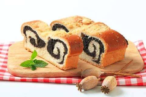 Sliced swirled bread with almonds on a table Stock Photos