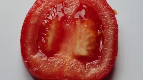 Sliced ​​tomato for the preparation of a salad close-up Stock Footage 336312867