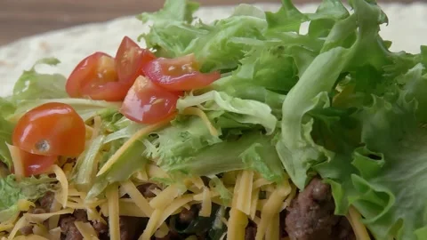 Sliced tomato sprinkled to buritto Stock Footage 292305688
