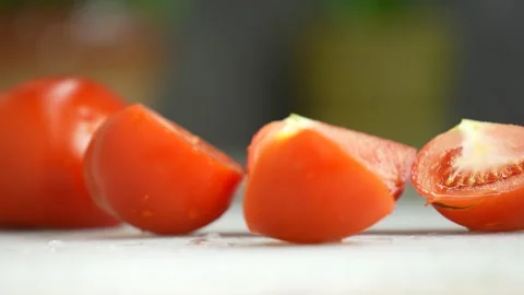 Sliced tomatoes, close-up. Man's hand with a knife cuts tomatoes Stock Footage 246382322